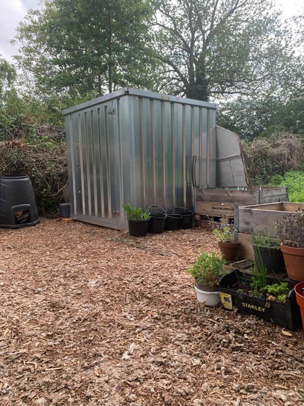 The metal tool store and raised beds